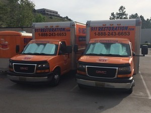 Water Damage Restoration Trucks At Job Location